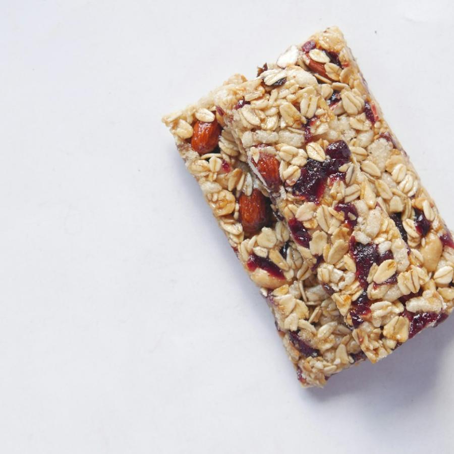 Oat and nut bar on a white surface