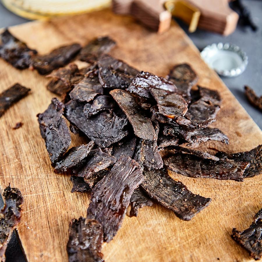 Sliced meat snack on a wooden board
