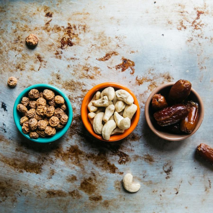 Three bowls of nuts and dried fruit